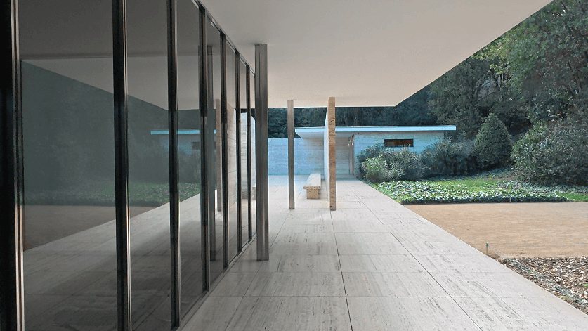 Barcelona Pavilion: the travertine terrace along the glass wall, the pool and the garden beyond.
